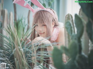 A woman in a pink bunny costume posing for a picture.