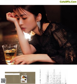 A woman sitting at a table with a plate of food.