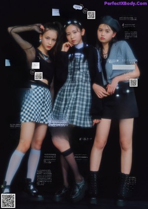 A group of young women standing in front of a poster.