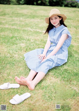 A woman sitting on a couch with her legs crossed.