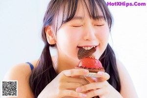 A woman in a pink tank top and shorts posing for a magazine.