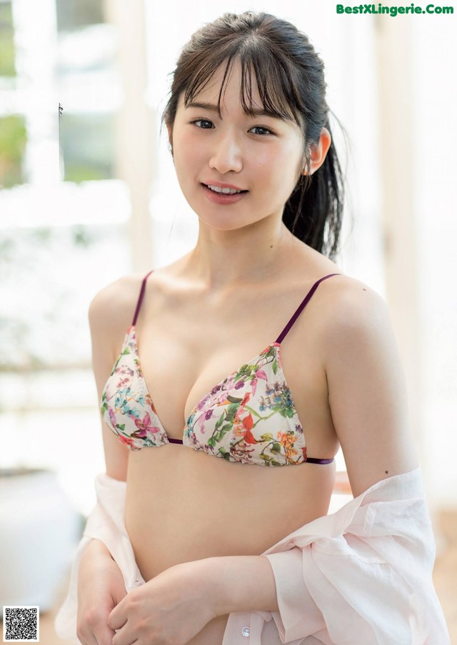 A woman in a floral bikini posing for the camera.