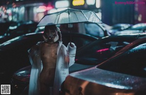 A woman wearing a gas mask standing in the middle of a street.